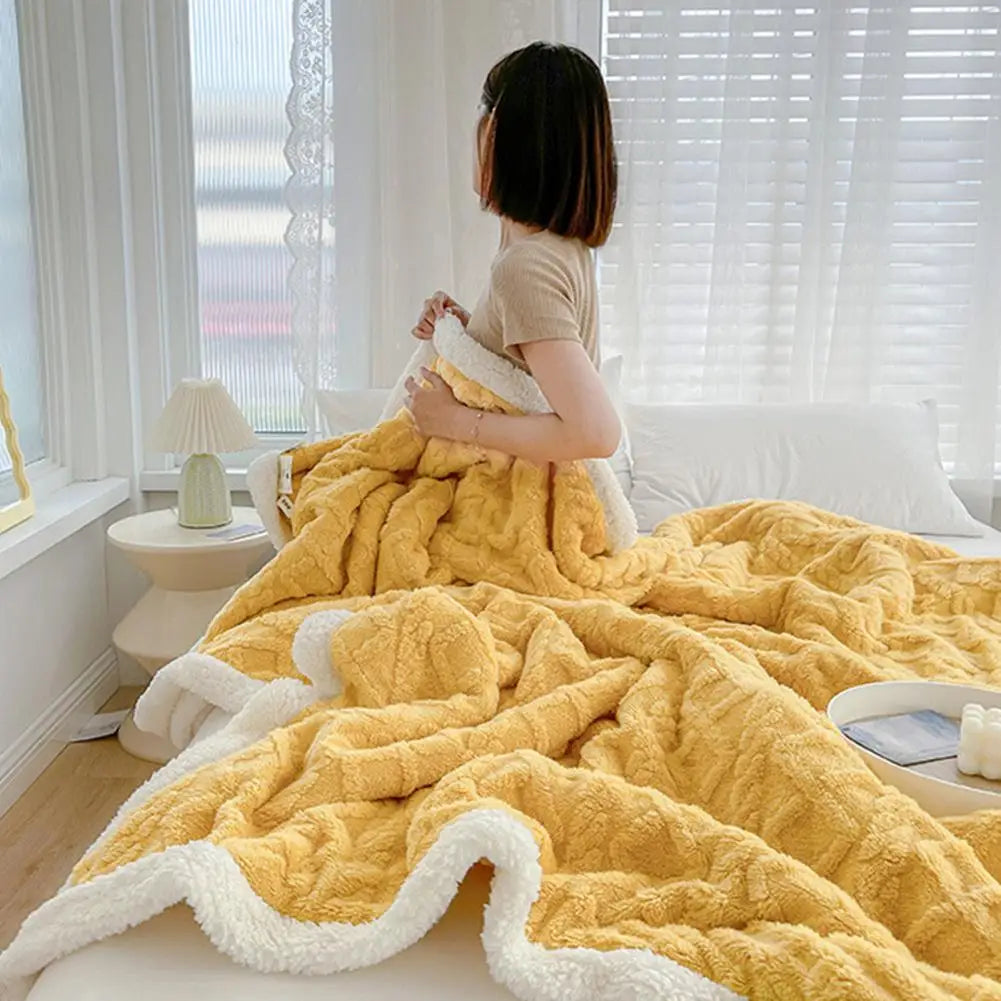 Couverture jacquard Nuitara — drapée sur lit, ambiance chambre cocooning